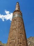 The Minaret of Jam is a UNESCO World Heritage Site in western Afghanistan. It is located in the Shahrak District, Ghor Province, by the Hari River. The 65-metre high minaret, surrounded by mountains that reach up to 2400m, was built in the 1190s, entirely of baked-bricks. It is famous for its intricate brick, stucco and glazed tile decoration, which consists of alternating bands of kufic and naskhi calligraphy, geometric patterns, and verses from the Qur'an (the surat Maryam, relating to Mary, the mother of Jesus).<br/><br/>

For centuries, the Minaret was forgotten by the outside world until rediscovered in 1886 by Sir Thomas Holdich, who was working for the Afghan Boundary Commission. It did not come to world attention, however, until 1957 through the work of the French archaeologists André Maricq and Gaston Wiet. Later, Werner Herberg conducted limited surveys around the site in the 1970s, before the Soviet invasion of 1979 once again cut off outside access.<br/><br/>

The archaeological site of Jam was successfully nominated as Afghanistan's first World Heritage site in 2002. It was also inscribed in UNESCO's list of World Heritage in Danger, due to the precarious state of preservation of the minaret, and results of looting at the site.<br/><br/>

The circular minaret rests on an octagonal base; it had 2 wooden balconies and was topped by a lantern. It is thought to have been a direct inspiration for the Qutub Minar in Delhi, which was also built by the Ghurid Dynasty. After the Qutub Minar in Delhi, India, which it inspired, the Minaret of Jam is the second-tallest brick minaret in the world.<br/><br/>

The Minaret of Jam belongs to a group of around 60 minarets and towers built between the 11th and the 13th centuries in Central Asia, Iran and Afghanistan, ranging from the Kutlug Timur Minaret in Old Urgench (long considered the tallest of these still in existence) to the tower at Ghazni. The minarets are thought to have been built as symbols of Islam's victory, while other towers were simply landmarks or watchtowers.